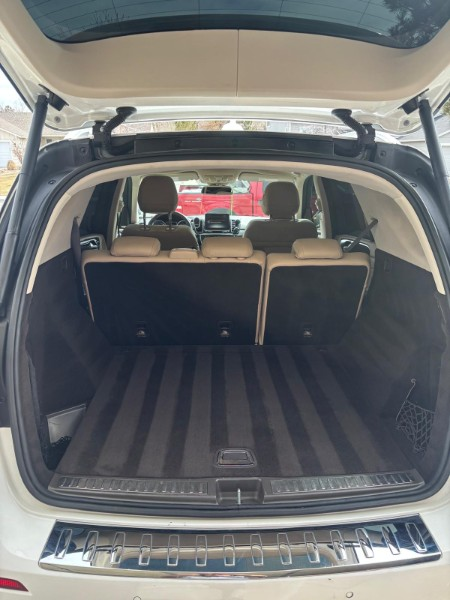 Clean tan cargo area of an SUV with the hatch open
