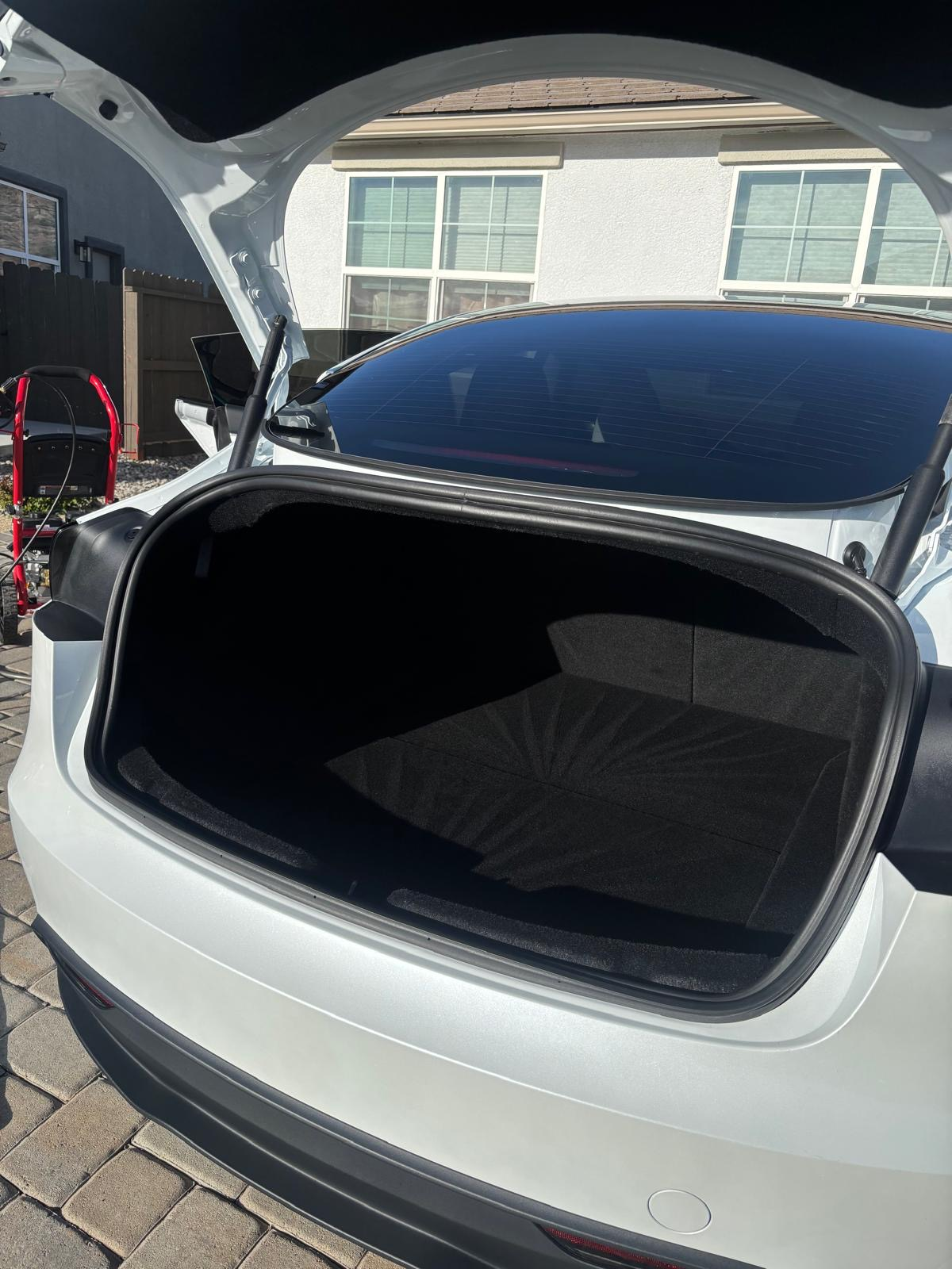 Detailed black trunk interior of a white Tesla